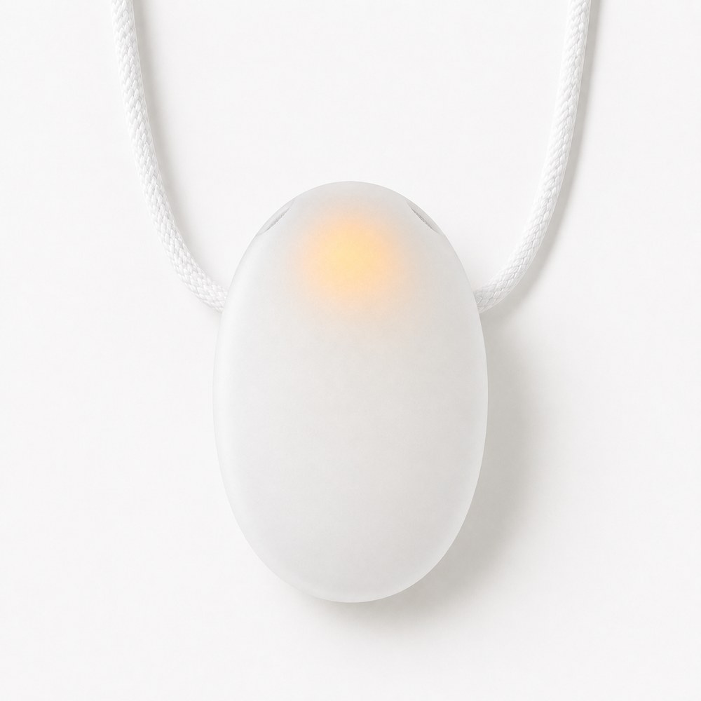 The Tombi pendant: a smooth white oval on a cord with a soft amber light